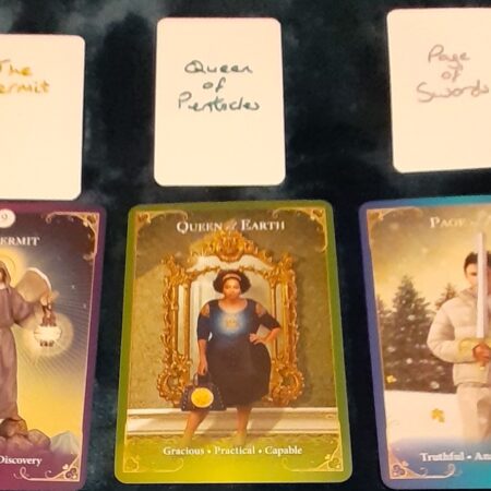 An example of a three card tarot reading, showing The Hermit, Queen of Earth, and Page of Swords